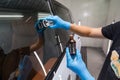 The process of applying a nano-ceramic coating Ceramic Pro Rain, 9h and Light on the car`s windows by a male worker with a sponge