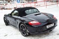 Rear view of the 2006 sports porsche boxster s coupe roadster prepared for sale with a polished shiny black body on snow winter at