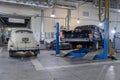 Rear view on two Russian classic vintage cars gaz m20 pobeda and 13 chaika in a repair shop in good condition one of then standing