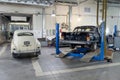 Rear view on two Russian classic vintage cars gaz m20 pobeda and 13 chaika in a repair shop in good condition one of then standing