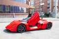 Sport Car Marussia Motors model B1 in red color and black roof front view. Photography of a Russian supercar near the hotel