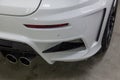 View of rear bumper and exhaust pipes luxury very expensive new white BMW X6 M Lumma CLR tuning car stands in the washing box