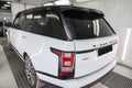 White and black Land Rover Range Rover Autobiography rear view in auto service garage waiting for wash and detailing