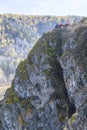 NOVOSOSEDOVO, RUSSIA - OCTOBER 8, 2020: Family with a child on top of a mountain cliff in the Siberian taiga in autumn