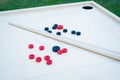 Novuss (also known as koroona or korona) is a large wooden board game where small wooden discs are hit with cue sticks Royalty Free Stock Photo