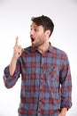 Now I remember. Studio shot of a young man looking with surprise at his finger. Royalty Free Stock Photo