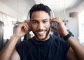 Now Im pumped. Portrait of a sporty young man listening to music while exercising in a gym. Royalty Free Stock Photo