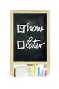 Now or Later with checkboxes - white chalk handwriting on blackboard Clipping path.