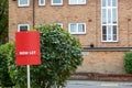 A now Let sign in front of a block of flats in the background Royalty Free Stock Photo