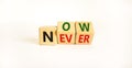 Now or never symbol. Turned wooden cubes and changed the word `never` to `now` or vice versa. Beautiful white background, copy Royalty Free Stock Photo