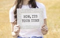 turn to write text, an inscription, a phrase in a frame that the girl is holding in her hands. Business concept Royalty Free Stock Photo