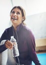 Now thats refreshing. an attractive young woman drinking water while working out at home. Royalty Free Stock Photo