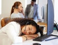 Now you know why nobody is answering your call. a young call centre agent sleeping at her desk in an office with her Royalty Free Stock Photo