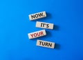 Now it is your turn symbol. Concept words Now it is your turn on wooden blocks. Beautiful blue background. Business and Now it is Royalty Free Stock Photo