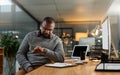 Nows a good time to call it a night. a handsome mature businessman sitting at his office desk and checking his watch Royalty Free Stock Photo