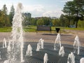 Noyabrsk, Russia - august 30, 2020: Central fountain. Jets of water rise up and scatter into small drops against the background of