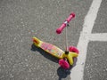 Noyabrsk, Russia - August 9, 2020: A pink and yellow child scooter with an image of Ariel stands on the concrete floor