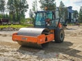 Noyabrsk, Russia - August 9, 2020: The tractor HAMM road roller ground vibratory roller stands on a sandy platform waiting for