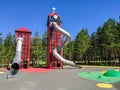 Noyabrsk, Russia - July 13, 2022: View of the playground in the city park. For children there are slides in the form of high metal