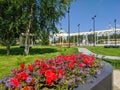 Noyabrsk, Russia - June 21, 2022: Beautiful view of a flower bed with red begonia flowers and a town square with a fountain and a