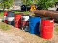 Noyabrsk, Russia - June 5, 2021: On a construction site, multi-colored iron barrels are lined up