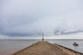 Fishermen in their boat coming back from the Atlantic ocean to avoid a heavy storm during a cloudy rainy afternoon Royalty Free Stock Photo