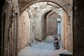 Motorcycyle standing in a typical street of the old town of Yazd, iran, with its typical clay walls