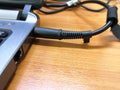 Plug in the notebook power supply cable Royalty Free Stock Photo