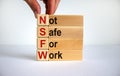 NSFW - not safe for work symbol. Wooden cubes with the word `NSFW - not safe for work` on beautiful white background, copy space
