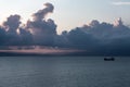 Sunset on the black sea in gray clouds. ship silhouette on the horizon