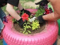 grandmother teaches teenage granddaughter to plant flowers