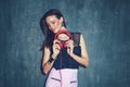 Nuanced stylish woman holding headphones at wall