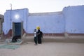 Nubian blue house at dusk with villagers