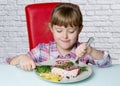 Nuce baby eats a big steak Royalty Free Stock Photo