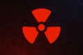 Nuclear energy radioactive ionizing atomic radiation round symbol shape painted on massive metal wall texture dark background.