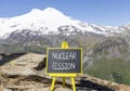 Nuclear fission symbol. Concept words Nuclear fission on beautiful black chalk blackboard. Chalkboard. Beautiful mountain Elbrus