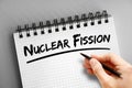 Nuclear fission text on notepad, concept background