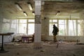 Nuclear post-apocalypse survivor in abandoned building, stalker life after war, man traveling on foot in a post Royalty Free Stock Photo