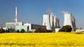 Nuclear power plant, cooling tower, field of rapeseed Royalty Free Stock Photo