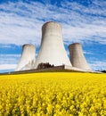 Nuclear power plant with field of rapeseed Royalty Free Stock Photo