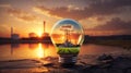 Nuclear power plant in light bulb at sunset. Royalty Free Stock Photo