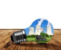 Nuclear power plant with solar panel and wind turbines in lightbulb. Royalty Free Stock Photo