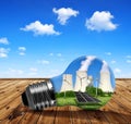 Nuclear power plant with solar panel and wind turbines in lightbulb. Royalty Free Stock Photo