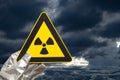 a nuclear radiation warning sign with dark and heavy clouds Royalty Free Stock Photo