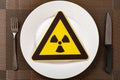 a nuclear radiation warning sign on a dish concept of unsafe food Royalty Free Stock Photo