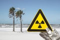 a nuclear radiation warning sign in front of a beach Royalty Free Stock Photo