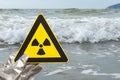 nuclear radiation warning sign in front of an ocean at horizontal composition