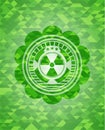 Nuclear, radioactive icon inside green emblem. Mosaic background