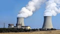 Nuclear reactor containment buildings with cooling tower in background