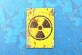 Nuclear site, sign hanging on a blue wall. Indication of the presence of a radioactive area